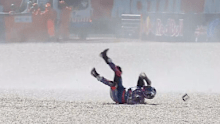 Jack Miller tumbles through the gravel at the MotoGP.