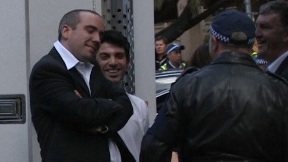 Julian Morrow and Chas Licciardello  are detained by the police