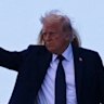 President Donald Trump and first lady Melania Trump wave before they board Air Force One at Leonardo da Vinci International Airport in Rome following the funeral.