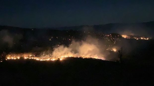 Rural Fire Service firefighter Julia Hopkins captures the glow of the Thornton bushfire in the Lockyer Valley.