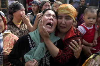 Uigher women grieve for men who they claim were taken away by the Chinese authorities after a protest in  Urumqi.