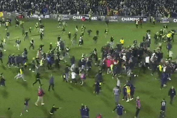 Mariners fans invade the pitch after the grand final.