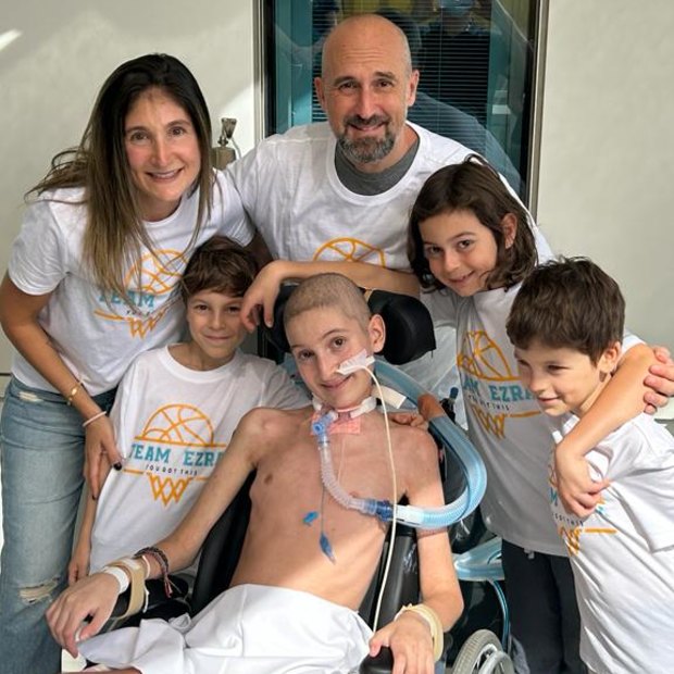 Ezra in hospital surrounded by his family (from left) mum Natasha, brother Alon, dad Dean and brothers Levi and Eden.