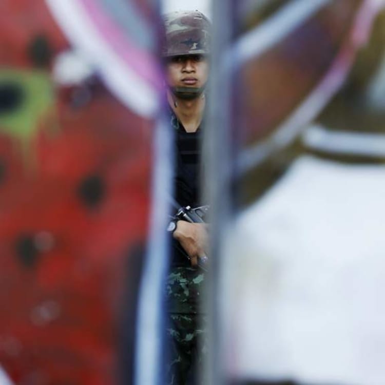 A Thai soldier is seen between barricades in Bangkok after the coup in May, 2014.