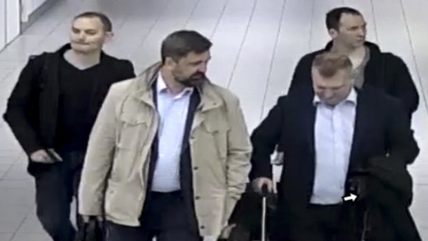 Four Russian officers are escorted to their flight after being expelled from the Netherlands on April 13, 2018, for allegedly trying to hack into the chemical watchdog OPCW's network. 