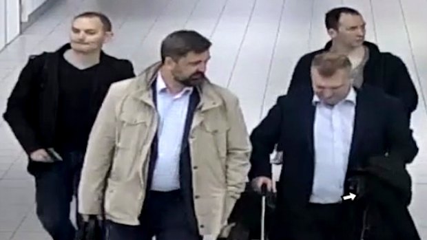 Four Russian officers are escorted to their flight after being expelled from the Netherlands on April 13, 2018, for allegedly trying to hack into the chemical watchdog OPCW's network. 