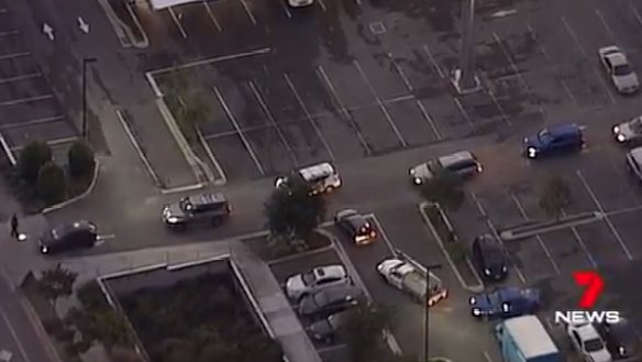 Officers search cars leaving the Woolworths complex at Pimpama.
