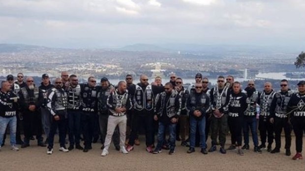 Nomads OMCG members pose for pictures on Mount Ainslie during a meeting in Canberra over the weekend.