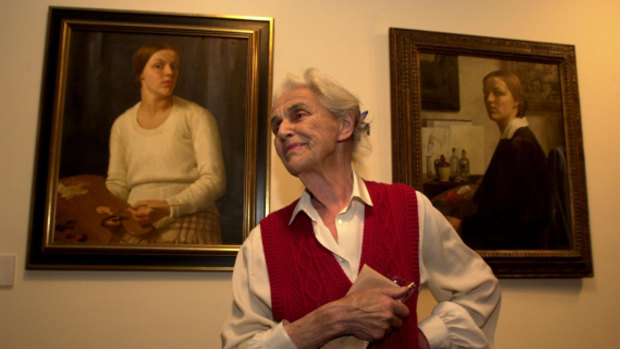 Nora Heysen seen in October, 2000 with two self-portraits from 1932.