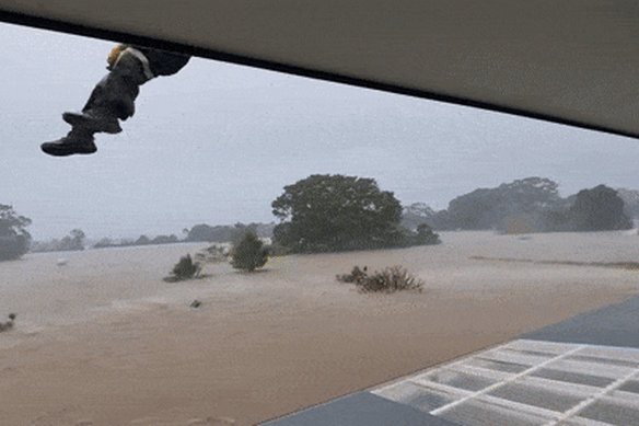 Dramatic vision of locals being rescued by helicopter.