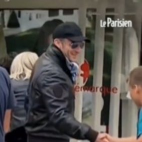 Emmanuel Macron in cap and sunglasses.