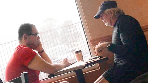 An IBAC surveillance photo of Casey councillor Sam Aziz (L) and developer John Woodman (R) at a Subway restaurant in April 2018. 