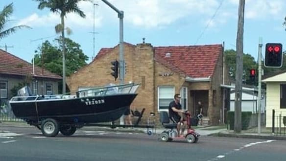Man charged for using mobility scooter to tow boat down Pacific Highway