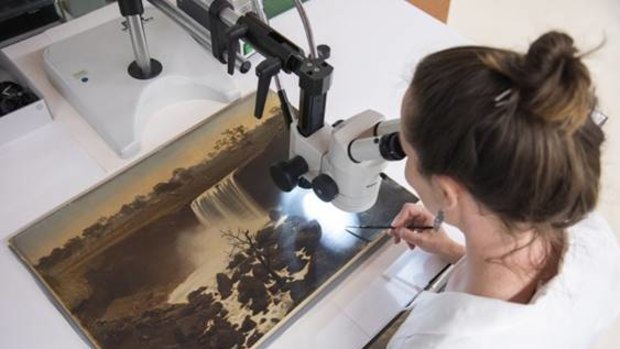 State Library of Queensland conservators are undertaking forensic analysis of the photographic paintings to undercover what was underneath them before painters in London painted over them.