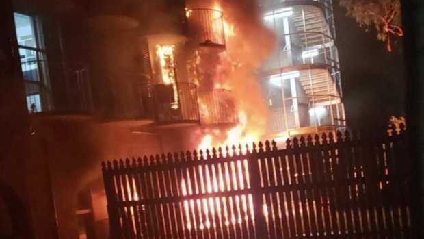 Flames take hold of an accommodation building at James Cook University in Townsville.