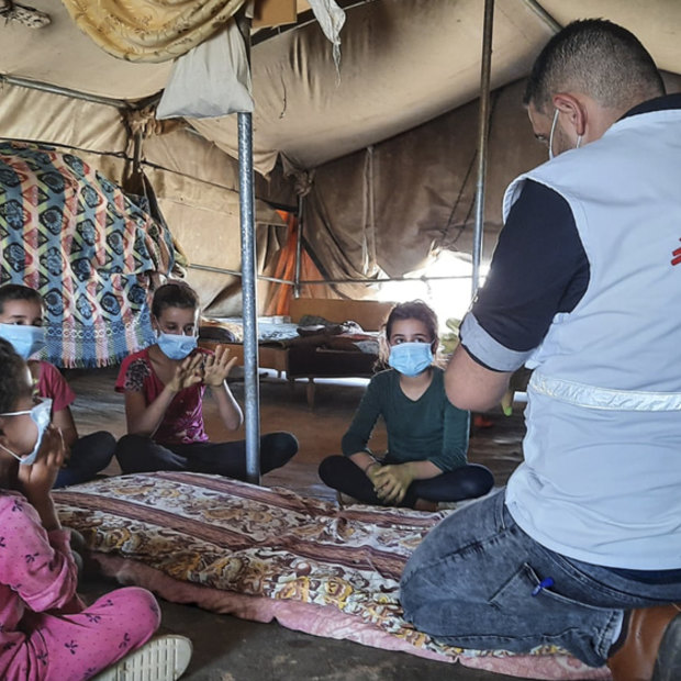 Doctors Without Borders educator Nader Owida conducts a COVID-19 health activity with children in Masafer Yatta, a collection of 19 Palestinian hamlets in the West Bank. 