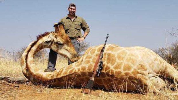 Blake Fischer poses with a giraffe he shot in Africa.