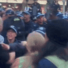 Police and protesters jostle as authorities try to stop the crowd from marching after the rally.
