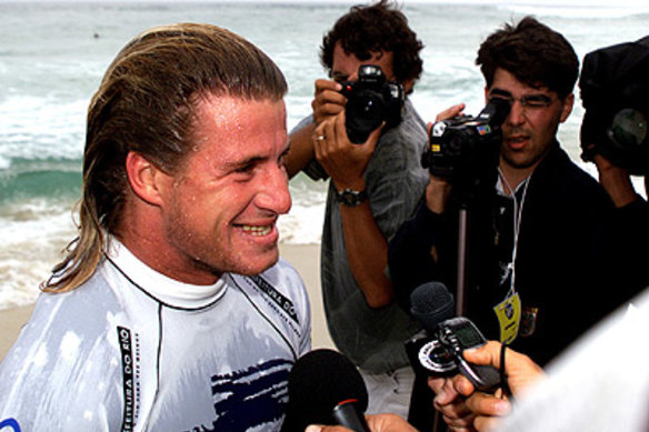 Winners are grinners: Occhilupo faces the press after being crowned world champion.