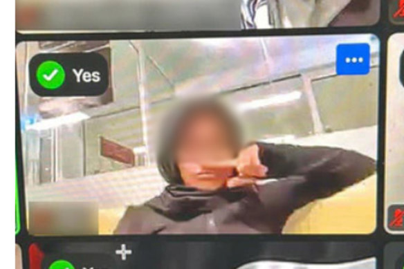 A screenshot of a student holding their finger to their nose, appearing to imitate a Hitler moustache.