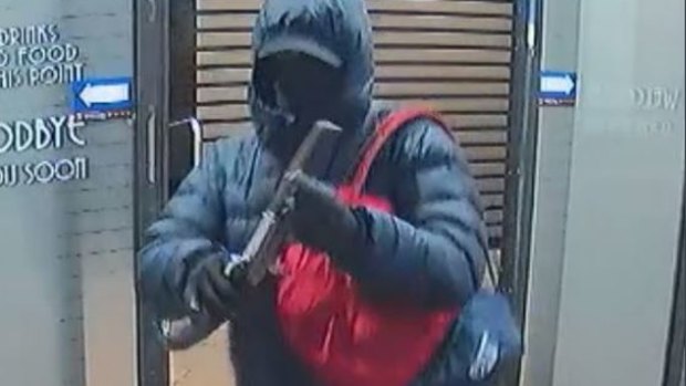 Queensland police issued an alert for an armed man who held up a Nundah business then made off with spare change from a tips jar.