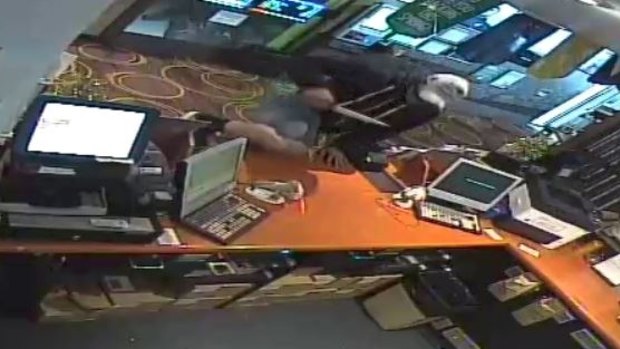 CCTV stills of a man believed to be responsible for a pokies venue armed robbery.
