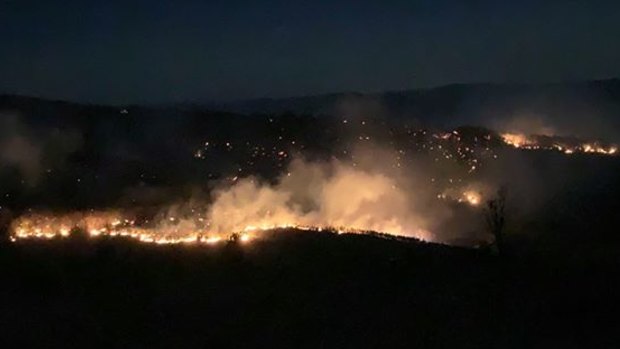 Rural Fire Service firefighter Julia Hopkins captures the glow of the Thornton bushfire in the Lockyer Valley.