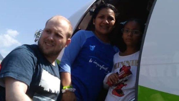 Joshua Holt, his wife Thamara and her daughter Marian Leal, board a plane at the airport in Caracas, on Saturday.
