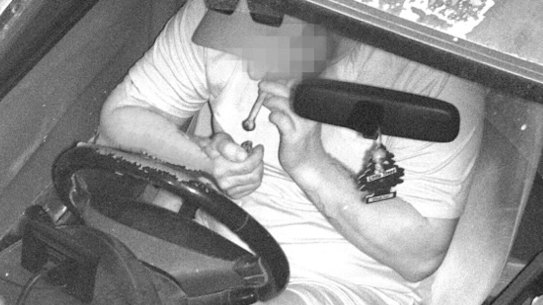 Smoking from glass pipe while not wearing a seatbelt. Image captured by WA’s new road safety cameras.