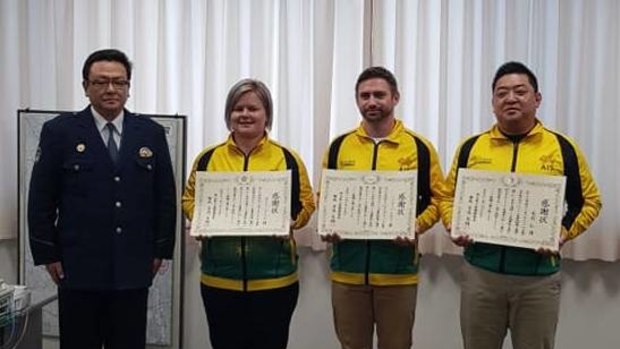 Heroes: Judo coaches Kylie Koenig, Hitoshi Kimura and Ben Donegan receiving their letters of appreciation from Japanese police.