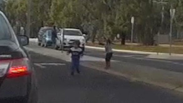 The children run onto the road.
