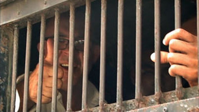 Ross Dunkley behind bars as shown in the documentary ‘Dancing with Dictators: The Story of The Foreign Publisher in Burma’.
