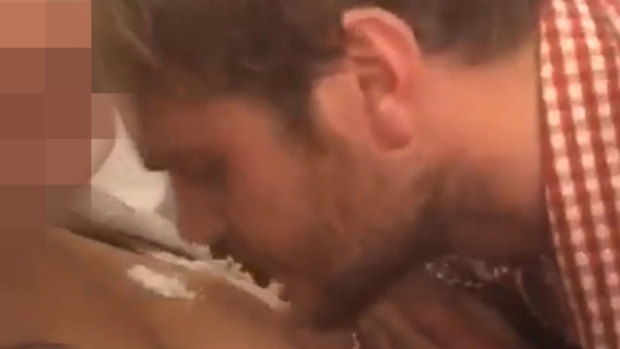 A screengrab from a video posted to Facebook of Port Adelaide footballer Jack Watts snorting a white substance, which his manager says is legal, off the chest of a woman at an Oktoberfest celebration in Europe last year.