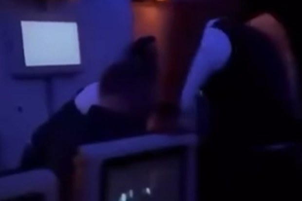 Fellow fliers jumped in to help flight attendants after claims the passengers had a gun and threatened to kill.