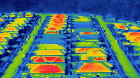 The urban heat island effect, seen through infrared imaging, shows the difference in temperatures black roofs make.