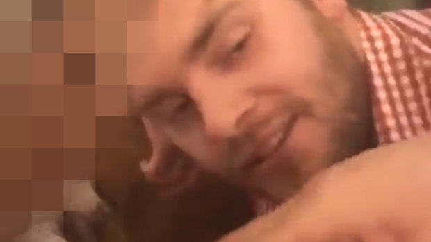 A screengrab from a video posted to Facebook of Port Adelaide footballer Jack Watts snorting a white substance, which his manager says is legal, off the chest of a woman at an Oktoberfest celebration in Europe last year.