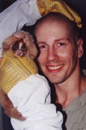 A rescued slow loris with Associate Professor Bryan Fry.