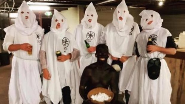 A screenshot of an Instagram post showing party-goers dressed in KKK and blackface costumes.