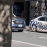 Footage of an individual allegedly riding a bike over a police car during a riot that erupted in Brisbane’s CBD at the weekend.