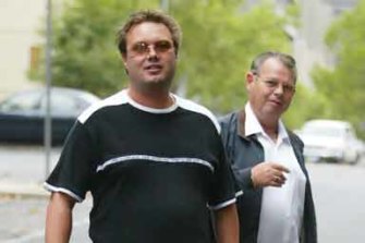 Carl Williams arrives at court with father George in April 2004.