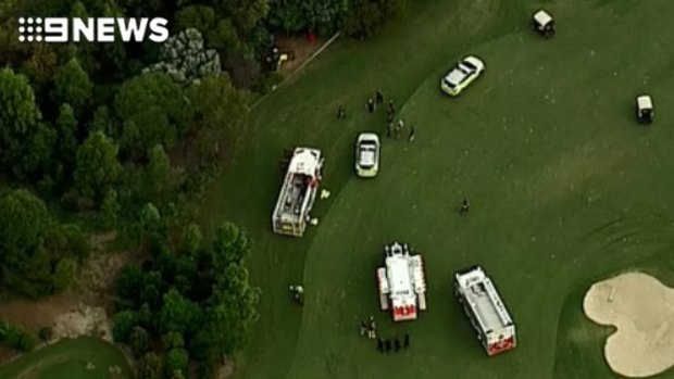 The man was trapped for about 30 minutes underneath the tractor at Indooroopilly Golf Club.