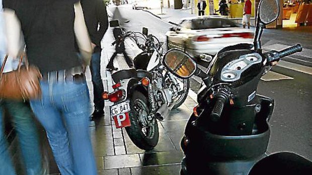 Motorbikes parked on the footpath in Melbourne's CBD.