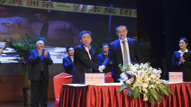 Vince Badalati, applauding at rear left, at the Tangshan ceremony in China.