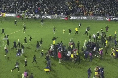 Mariners fans invade the pitch after their grand final victory.