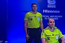 Australian ref Shaun Evans makes the gesture on worldwide television.