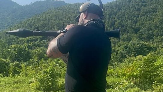 Daniel Jones, who runs a self-defence outfit, has posted pictures and videos of himself wielding guns and even rocket launchers online.