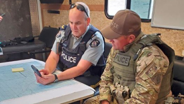 Canadian RCMP members plot out a course in the Gillam area of Manitoba.  