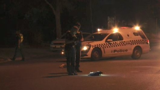 Police inspecting items left on the road after they were called to reports of an injured man on East Derrimut Crescent.