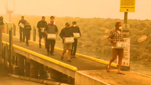 Supplies are unloaded at Mallacoota on Thursday.