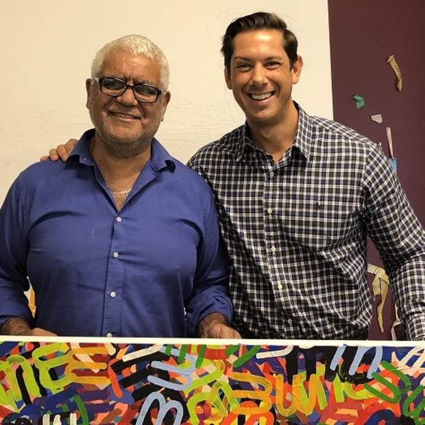 IndigiLedger founder Adam Robinson (right) with artist Richard Bell in his studio.